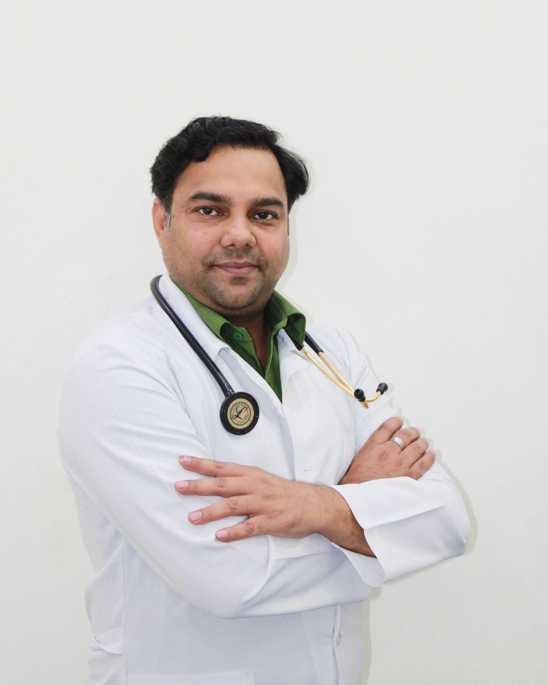 Approachable Indian dentist in a white coat, smiling at the camera